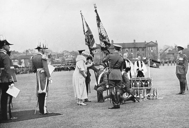HM Queen Mary, Colonel-in-Chief of the Regiment, presenting the new King’s Colour 