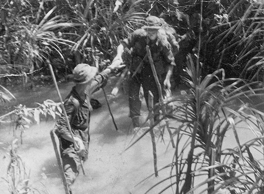 A signaller being helped across a stream by his Sergeant - 8PL Fort Iskander.