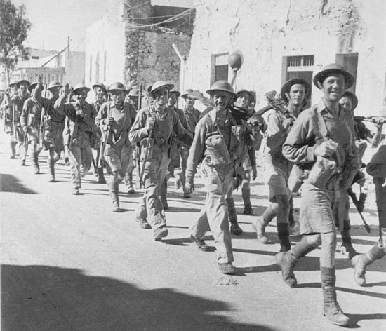 Soldiers of 1/6th Queen's passing through Tobruk on their way to the docks.